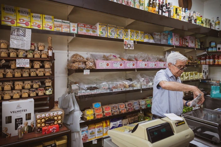 Dried goods – from fruits and nuts to manioc flour – line the back wall of the shop Mercearia do Galo grocery in Porto